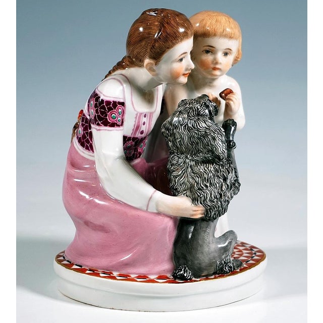 Excellent, rare meissen children group: kneeling girl with long braided hair in a long pink and white dress with elaborate...