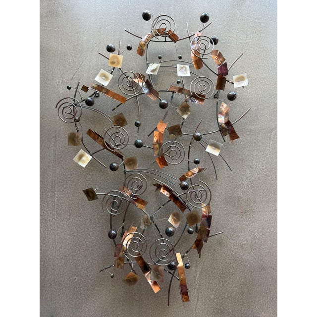 This abstract wall sculpture was created by Curtis Jeré, Artisan House in 2004, as inscribed on the frame. The postmodern...