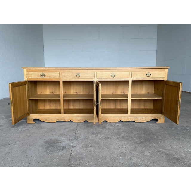 Striking Danish Modern oak sideboard produced by Hundstrup Møbelfabrik, Denmark, circa 1970s. Crafted in solid oak and oak...