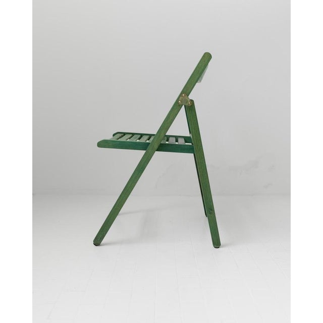 This vintage wooden folding chair from the 1970s by Realpina, Italy is a practical and stylish example of functional...