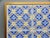 A set of matching 19th-Century Dutch Delft tiles in a blue and yellow geometric pattern. They have been professionally...