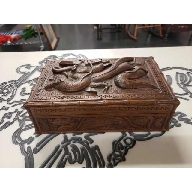 This is a Vintage Mid Century Chinese Hand Carved Wood Dragon Keepsake Lidded Box. It measures 2 1/2" high x 8 1/4" wide x...