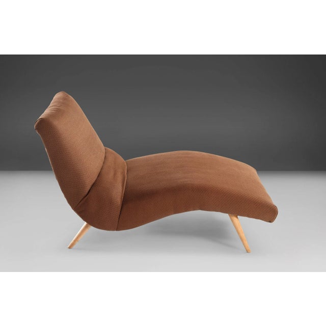 A contoured build sure to be the statement piece in your living space. Found in the original upholstery and set on maple...