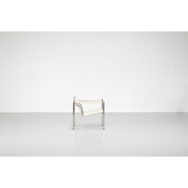 "LC1" armchair in white leather on a metal frame. Designed by Le Corbusier, Charlotte Perriand, and Pierre Jeanneret for...