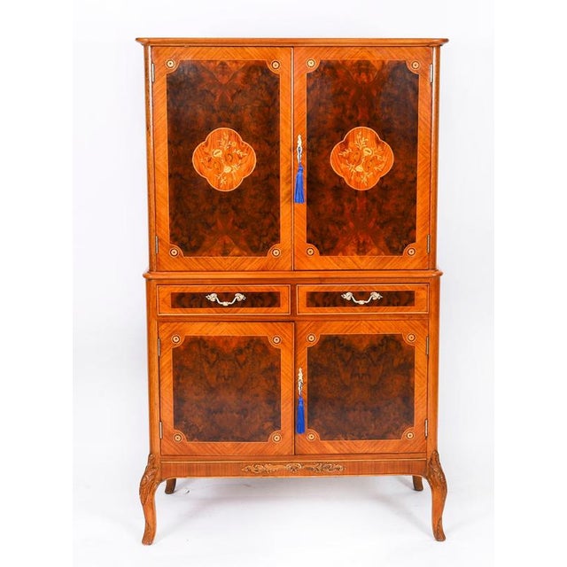 This is a superb antique demi lune Art Deco cocktail cabinet, circa 1930 in date by Harry & Lou Epstein of London. The...