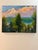 Sunset featuring beautiful colors in the clouds as seen through the forest above the mountain lake. One-of-a-kind original...