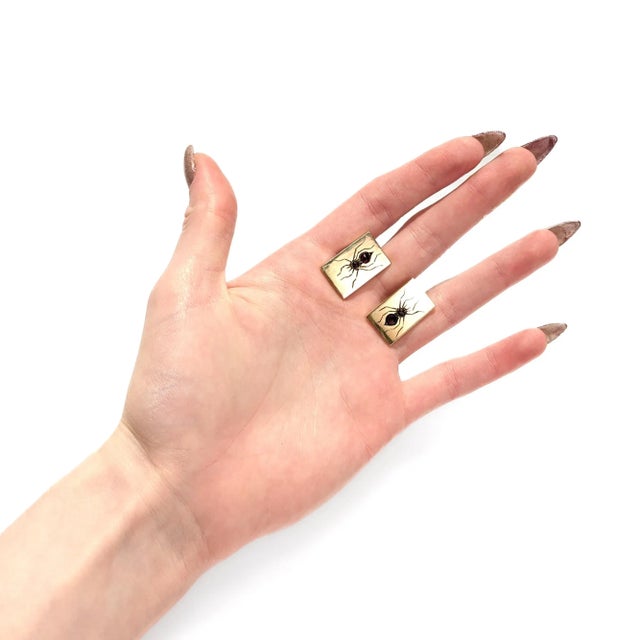 A fine vintage pair of Mid-Century spider cufflinks. In 14 karat yellow gold. Each rectangular cufflink with a spider with...