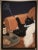 Chic black cat art print featuring a stylish black feline draped with a white fur accent. Elegant wall decor that adds...