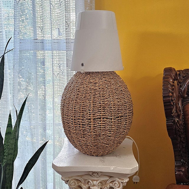 Textural vintage IKEA table lamp featuring a rounded, handwoven natural rattan/seagrass-style fiber body topped with a...