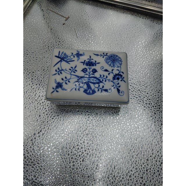 This trinket box was once used as a cigarette case. The MEISSEN ONION PATTERN has a porcelain finished; the two-piece top...