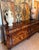 This stunning bombe-shaped credenza exudes old-world craftsmanship. Featuring intricate floral marquetry inlays across its...
