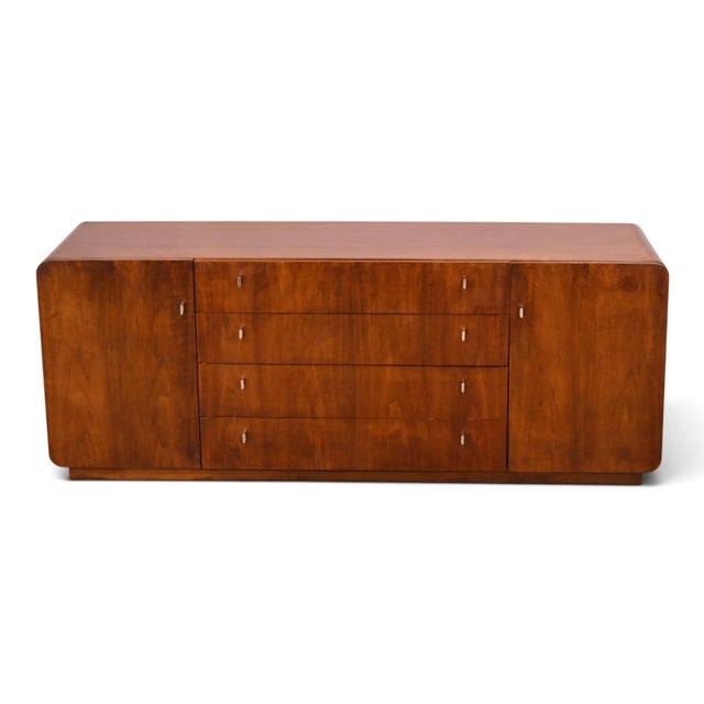 This Founders Furniture lowboy dresser pairs warm walnut with chrome in the sleek, softened geometry the maker was working...
