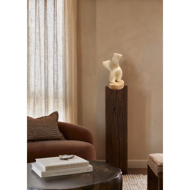 California artist Frank Lauren hand carved this abstract torso out of alabaster and mounted it to a marble base. It is not...