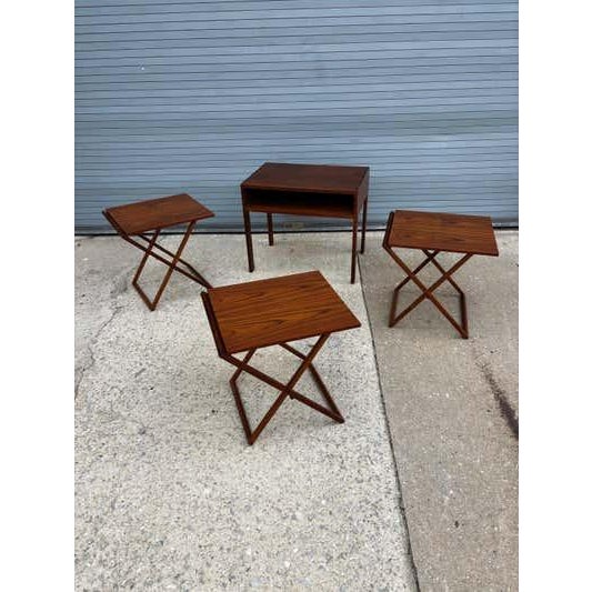 Set includes three folding tables that fold flat and slide into slotted spaces of the occasional Table. Table looks like...