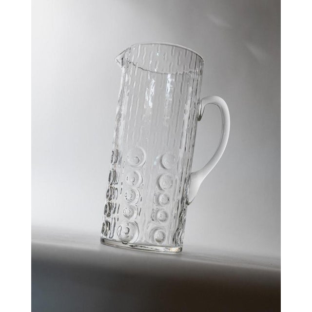 This vintage hand-blown glass pitcher from the 1970s by **JH Elegance, Belgium** is a beautiful example of sculptural mid-...