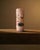 A charming example of Victorian decorative glasswork, this petite cylindrical vase is rendered in soft blush-pink opaline...