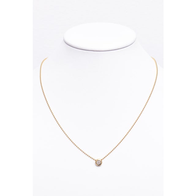 Beautifully made Italian diamond pendant featuring an approximate .20 carat round diamond set into an 18k yellow gold...