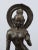 A distinctive bronze temple statue originating from India, made using the traditional casting technique. The figure is...