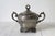 Antique quadruple-plate footed lidded sugar bowl, produced by E.G. Webster & Son. Features ornate, hand-chased or embossed...