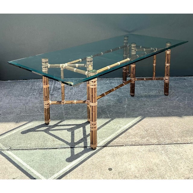 This striking vintage dining table, attributed to the iconic McGuire Furniture Company of San Francisco, epitomizes the...