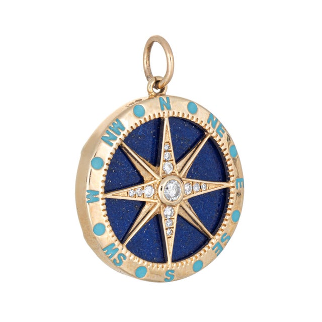 Distinct & stylish contemporary Compass pendant crafted in 14 karat yellow gold. Set with a lapis lazuli backdrop the...