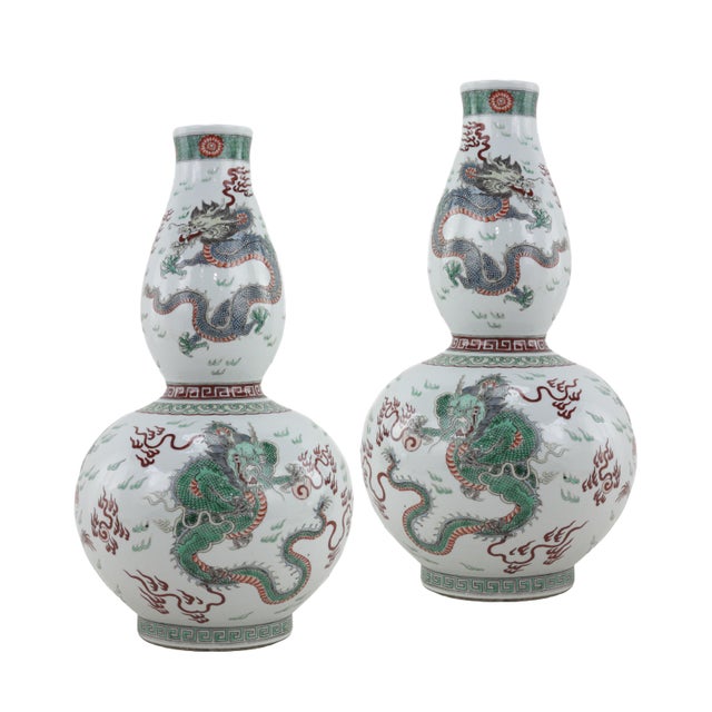 The vases are gourd-shaped, with two conjoined bellies, standing 17.5 inches tall. The primary decoration features a pair...