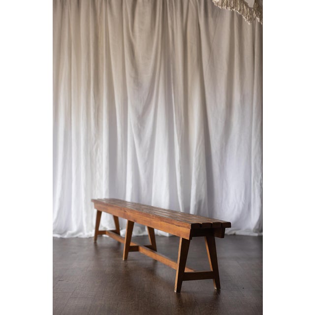 This vintage slatted wood bench features clean lines and a simple, functional design that highlights the natural beauty of...