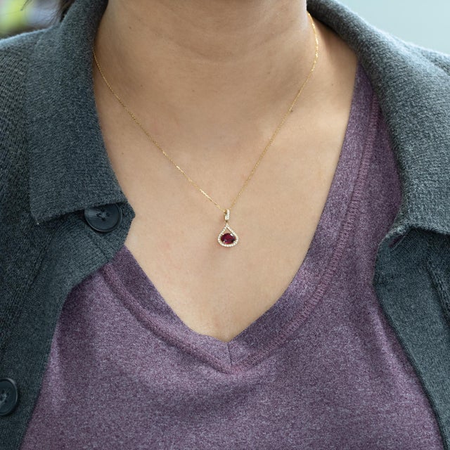 A vibrant 1ct rubellite tourmaline radiates rich raspberry-pink hues, accented by natural diamonds in solid 14K gold. A...