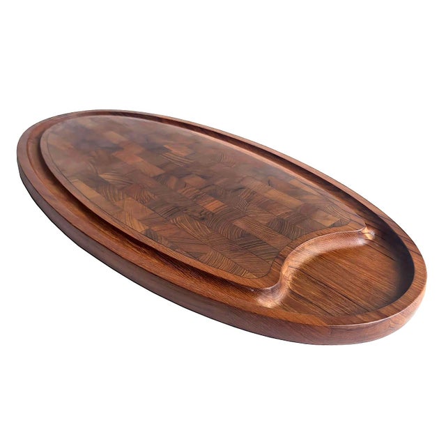 Offered is an elongated oblong carving / charcuterie board made of staved Teak wood with an end grain butcher-block inlay...
