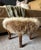 Antique wooden footstool newly upholstered in genuine coyote fur repurposed from a vintage coat. The full, plush fur...