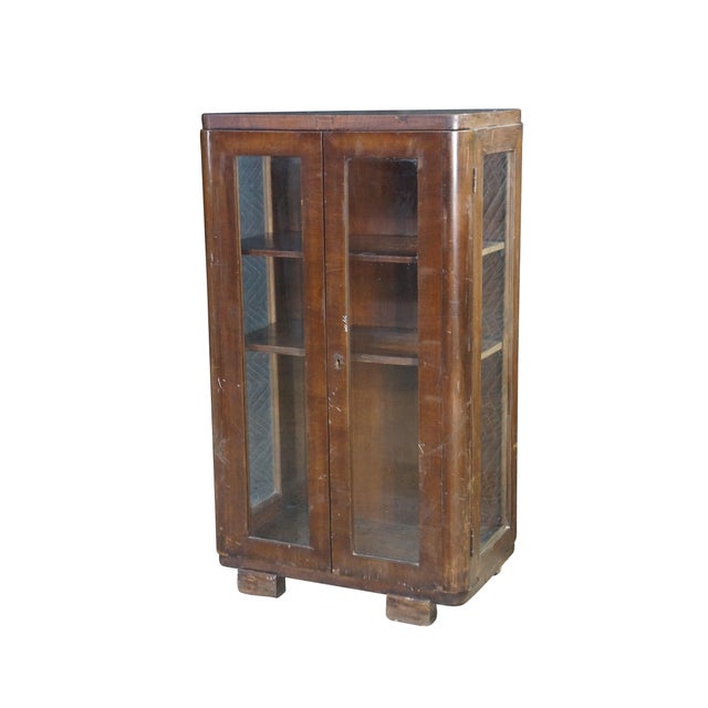 Antique Art Deco curio cabinet / bookcase / console. Made of mahogany featuring long doors with two shelves and glass...