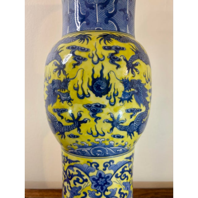 A striking vintage Chinese porcelain floor vase featuring a vibrant famille jaune yellow ground with richly hand painted...