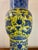 A striking vintage Chinese porcelain floor vase featuring a vibrant famille jaune yellow ground with richly hand painted...