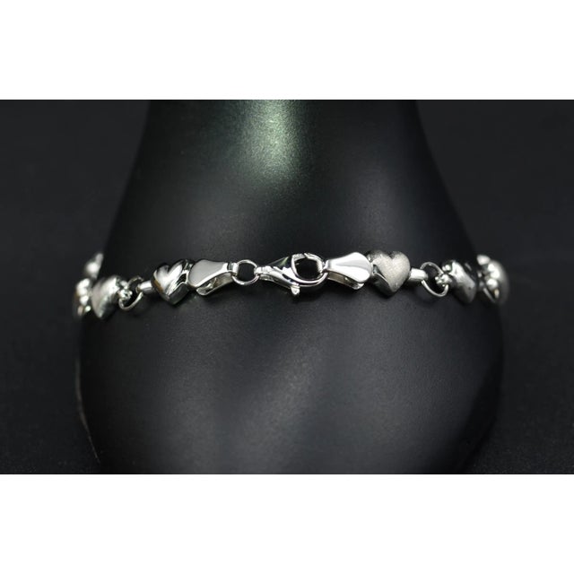 The Rovenna Ladies Simple 14K Gold Heart Chain Bracelet. This contemporary style bracelet is crafted in 14 karat white...