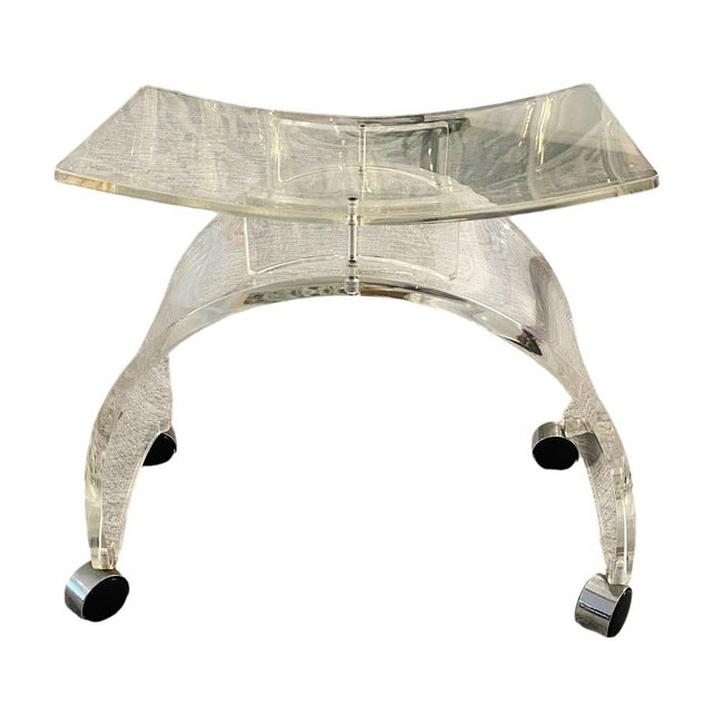 Mid-Century Modern Lucite Vanity Stool (On Casters) Dims: 21"W x 12"D x 18"H This is a mid-century modern Lucite vanity...