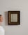 This piece presents as a mirror, distinguished by dark bronze/gold ornate carved frame with red edge. Dating to 19th...
