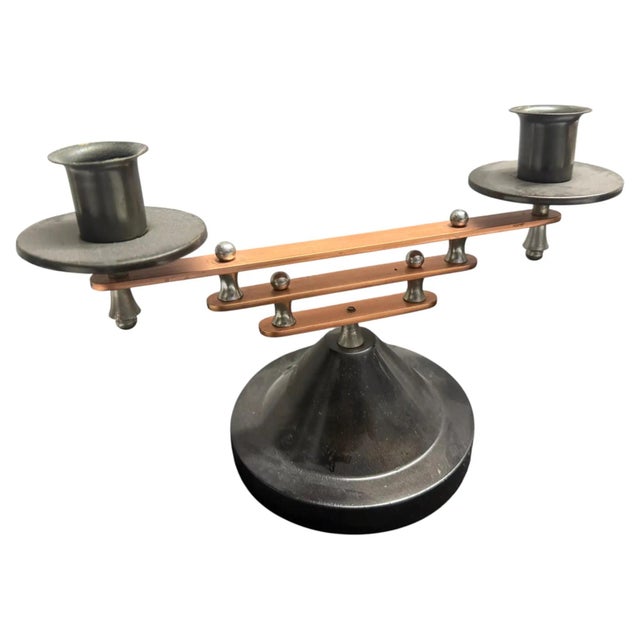 A rare and striking pair of 1930s French Art Deco two-light candelabras, masterfully crafted in a bi-metallic blend of...