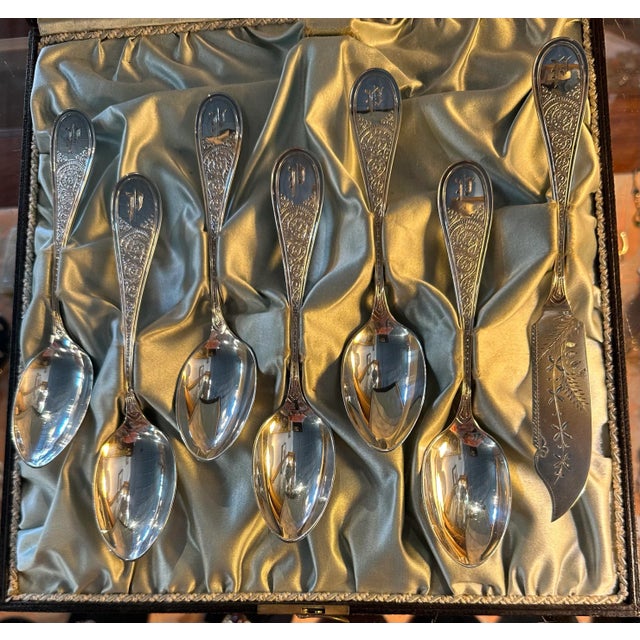 This set is in excellent condition. The handles are decorated with a scrollwork pattern, and they are monogrammed with a...