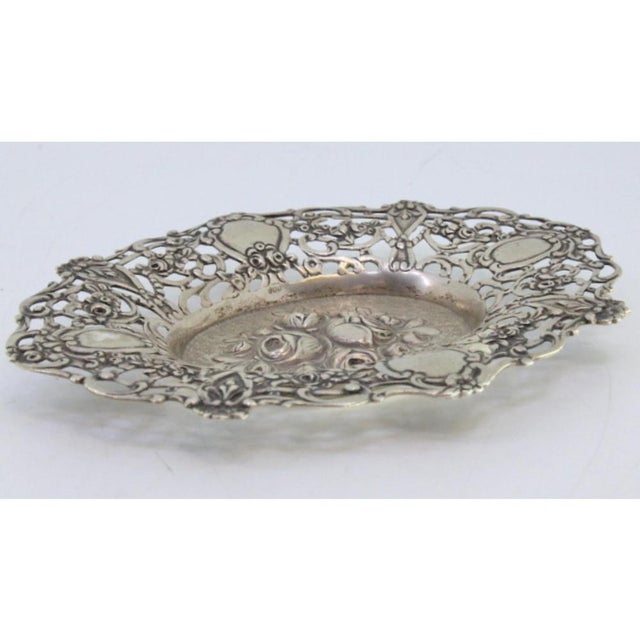 Silver Bowl with Central Bouquet of Roses and Floral Motifs, in Very Good conditions. Designed from 2000 This piece has an...