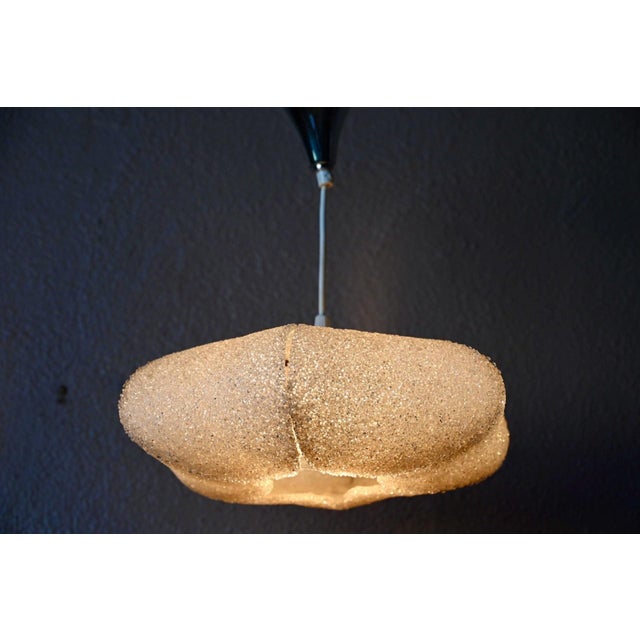 A beautiful memory from the 1960s graces your ceiling with this undeniably charming pendant light. Its translucent acylic...