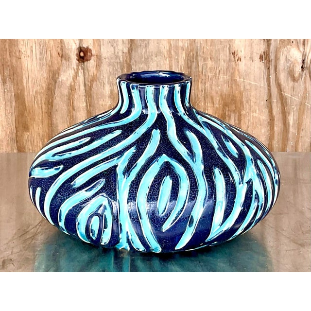 An exceptional vintage hand-thrown studio pottery vase, distinguished by its dramatic low-profile silhouette and richly...