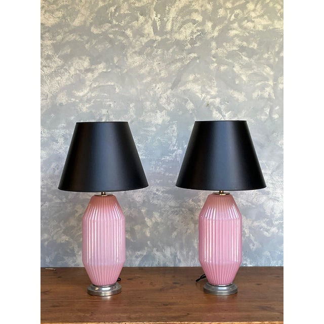 A beautiful pair of Italian Mid-Century Murano glass table lamps in a soft cyclamen pink, featuring delicately ribbed...