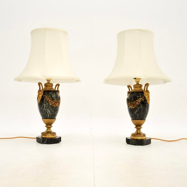 An absolutely stunning pair of antique French marble and gilt bronze lamps. They were made in France, they date from...