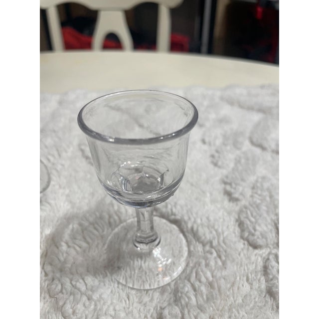 A charming vintage glassware set featuring four petite textured mugs paired with a delicate stemmed cordial glass. Each...