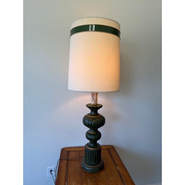 Striking oversized vintage table lamp featuring a sculptural dark green base with warm gold accents and a tall cylindrical...