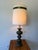 Striking oversized vintage table lamp featuring a sculptural dark green base with warm gold accents and a tall cylindrical...