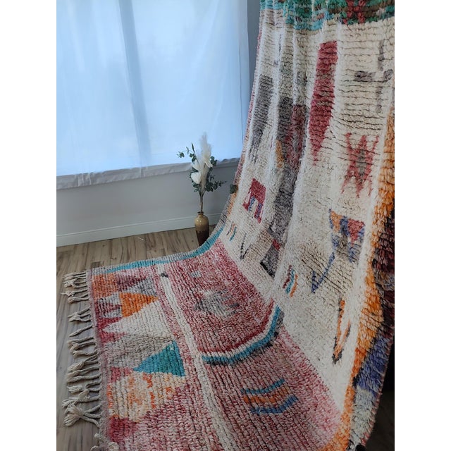 One-of-a-kind handwoven Boujaad rug from the Atlas Mountains of Morocco. A dense field of tribal symbols — crosses, flags,...