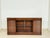 An elegant and high-quality office sideboard made of fine, dark-stained wood in the classic English colonial style. The...
