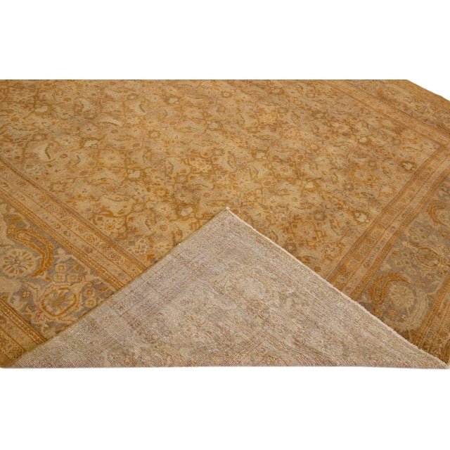 Beautiful antique Persian Sultanabad hand-knotted wool rug with a tan field. This piece has a gray designed frame with...