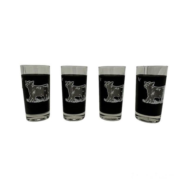 A unique set of 4 vintage glasses featuring a cow and butterfly motif. Rare set. The texturized black paint is perfect for...